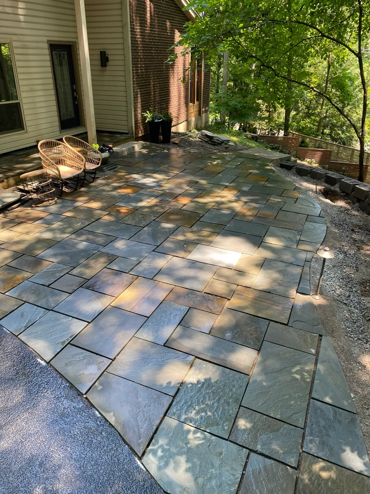Natural-stone patio completed by Queen City Hardscapes